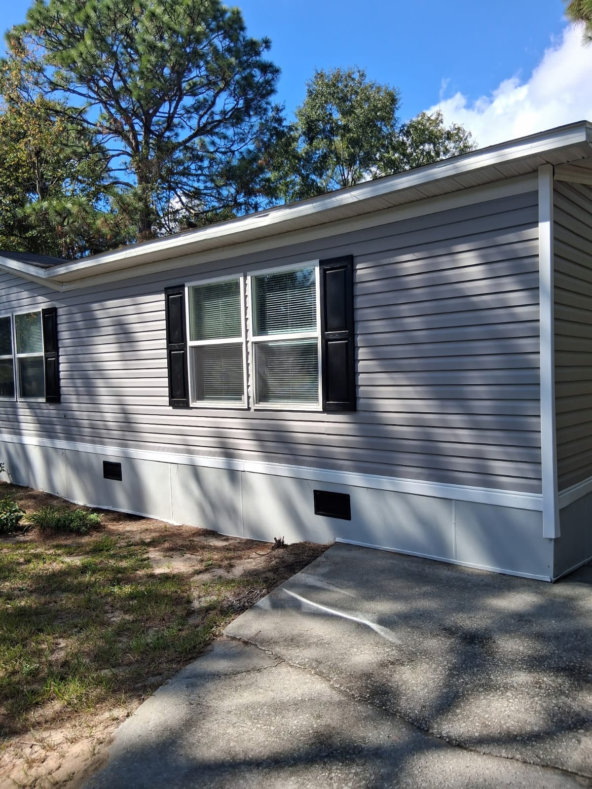 White gutters along the side of a gray home
