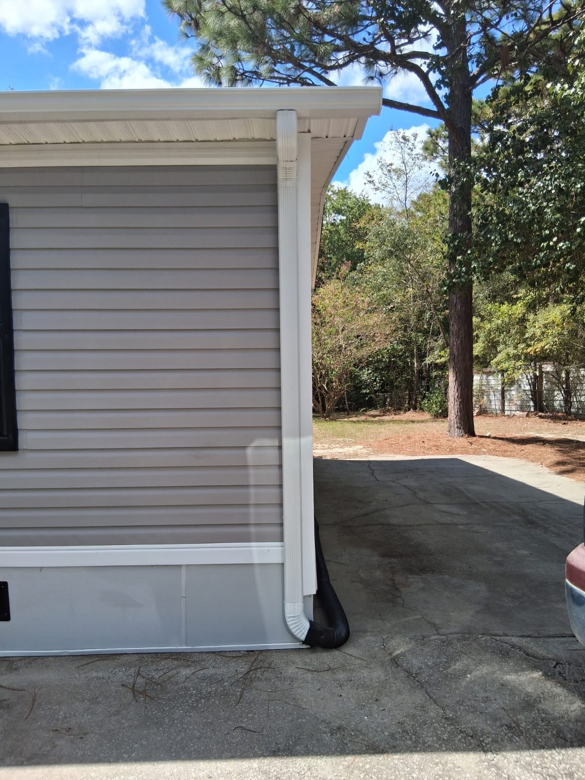 White downspout at the corner of a home